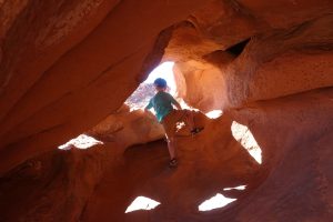 Valley of Fire, preschooler climbing Preschooler climbing an orange rock, looks like he's coming out of some kind of cave