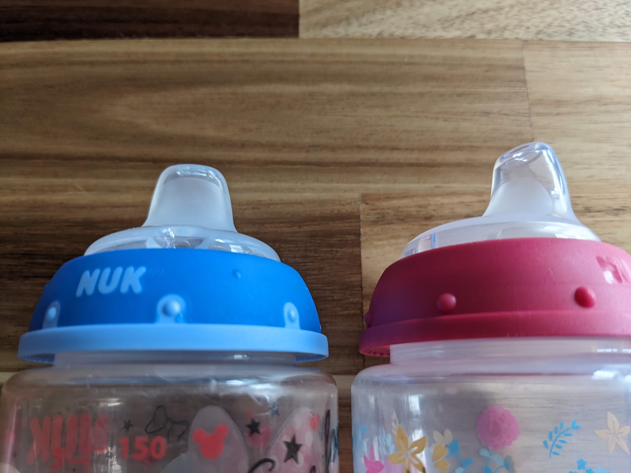 Blue Nuk Spout for sippy cup and pink non-name brand spout for comparison